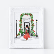 Framed artwork of a woman in a red dress standing in front of a decorated archway with Christmas decorations.
